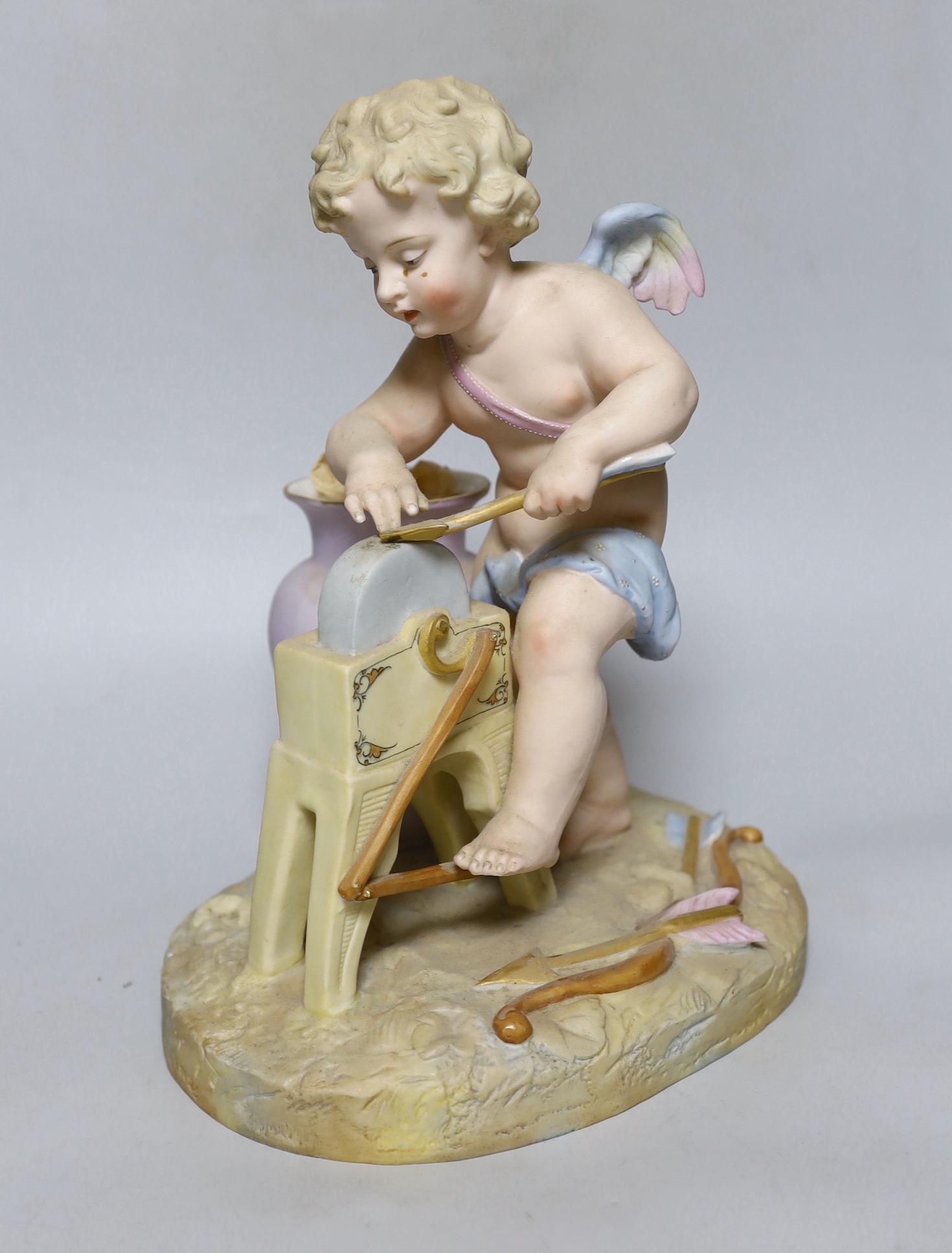 A continental bisque porcelain figure group, Cupid at work, 27cm